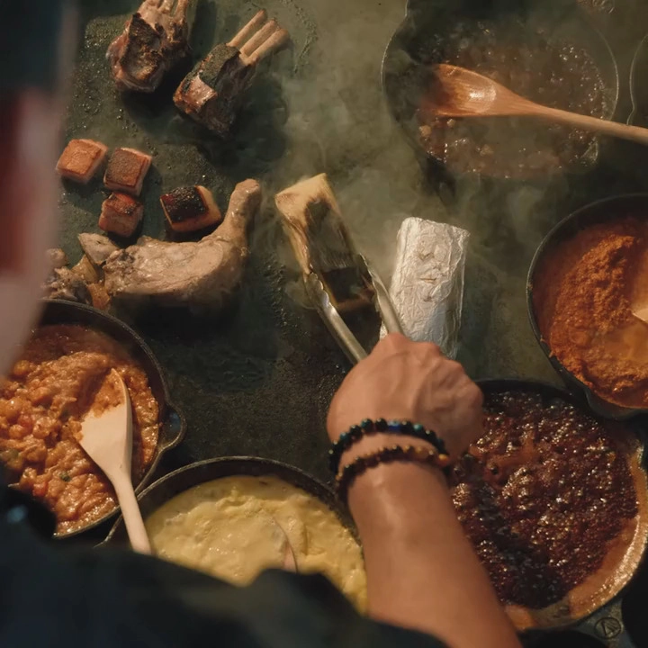 man cooking tamale with metal spatula
