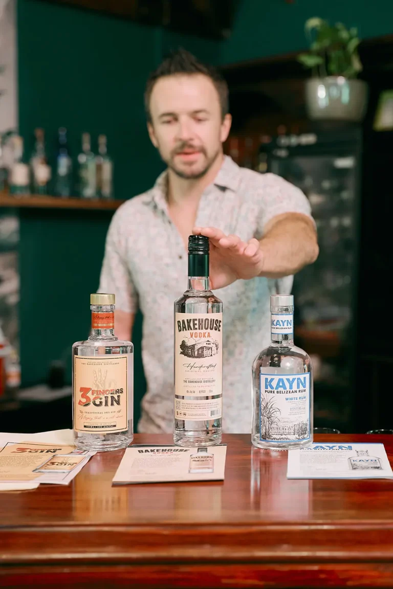 white man pointing at belizean rum in cocktail class