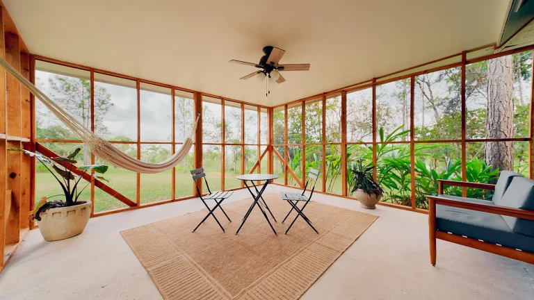 lounging indoor verandah with hammock and view of belize pine forest
