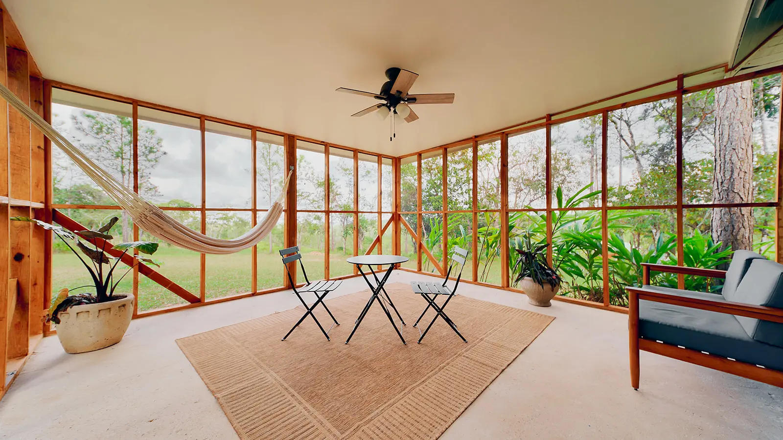 lounging indoor verandah with hammock and view of belize pine forest