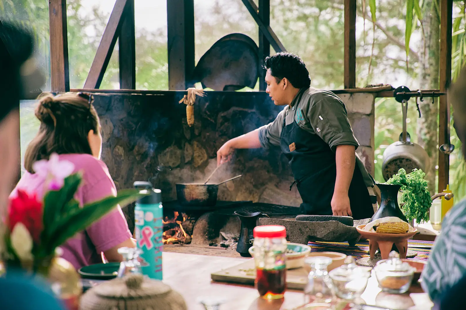 man teaching cooking class belize